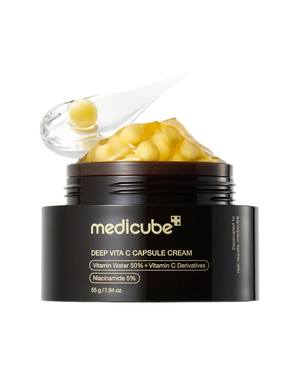 A black jar of medicube Deep Vita C Capsule Cream with a clear lid showing yellow gel capsules, on a white background.