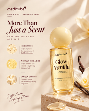 Medicube Glow Vanilla hair and body fragrance mist bottle displayed on a stone pedestal with vanilla flowers, vanilla bean, and droplets, alongside product benefits text on a warm beige background.