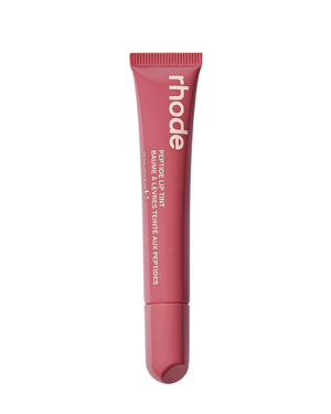 Rhode Pequirol Lip Tint in a dusty rose pink squeeze tube with white text, shown against a solid white background.