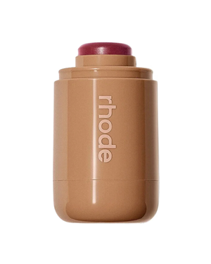 A Rhode makeup stick in a warm tan-berry shade, shown on a solid white background.