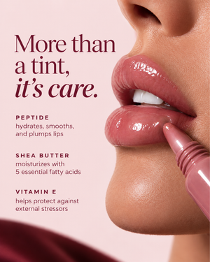 Close-up of a person applying a pink lip product to their lips against a soft pink background, with text reading 'More than a tint, it's care.' and ingredient callouts for peptide, shea butter, and vitamin E.
