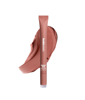Lipstick tube with a swatch of pink lipstick on a white background