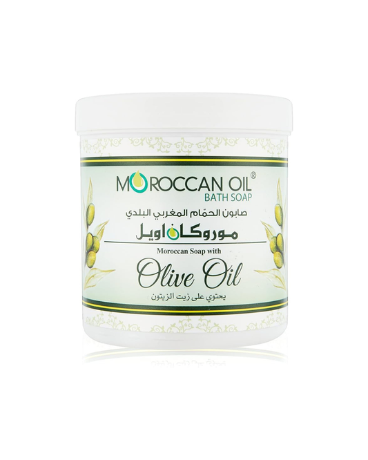 A white plastic jar of Moroccan Oil Bath Soap with Olive Oil, featuring a white label with green and black text and illustrations of olives.