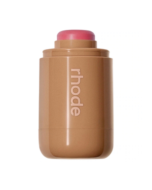 A Rhode makeup stick in a pink shade  shown on a solid white background.